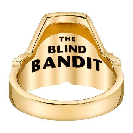 Close up of Earth Kingdom emblem in green enamel on gold ring
